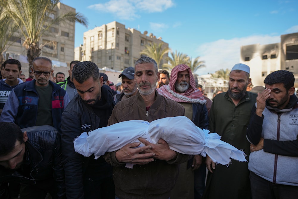 The body 18-month-old Sham Shurrab is carried by her uncle for burial in the aftermath of an Israeli airstrike at the Muwassi camp, outside the Nasser hospital in Khan Younis, southern Gaza Strip, on December 5, 2024. (AP)