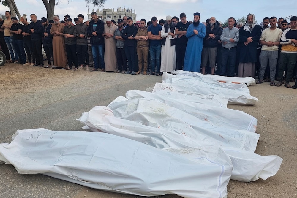 Mourners pray over the bodies of members of the Abu Taha family who were killed in an Israeli airstrike, during their funeral at Al-Salam cemetery, east of Rafah, Gaza Strip, April 29, 2024. (AP)