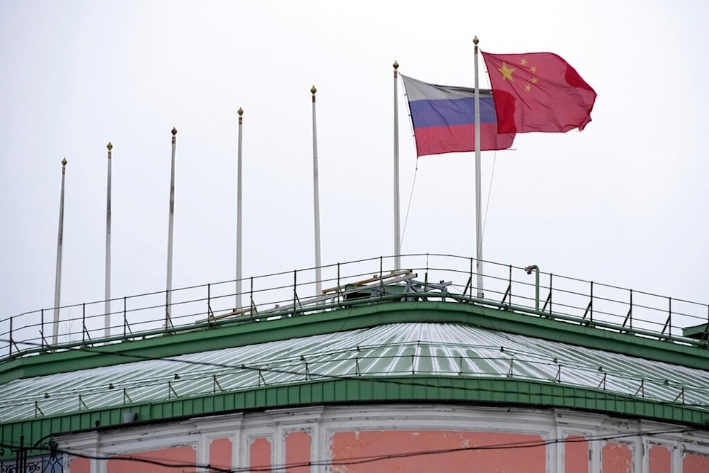 The flags of Russia and China flutter on the roof of a hotel with the flags of other countries removed, in central St. Petersburg, Russia, Wednesday, Nov. 30, 2022. (AP Photo/Dmitri Lovetsky)