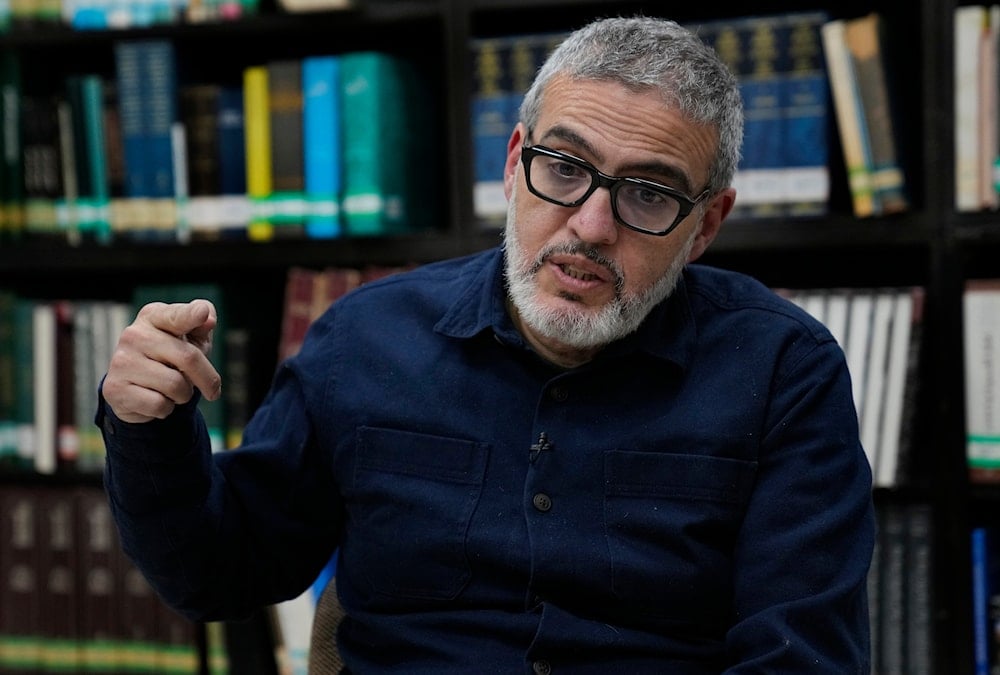 Doctor Ghassan Abu Sitta, a Palestinian-British plastic surgeon specializing in conflict medicine, speaks during an interview with The Associated Press at the Institute for Palestine Studies in Beirut, Lebanon, Saturday, Dec. 9, 2023. (AP)