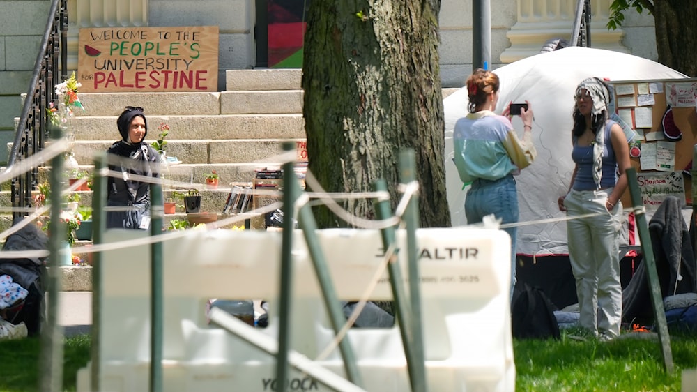 Students near the remnants of an encampment of tents in Harvard Yard, on the campus of Harvard University, Tuesday, May 14, 2024, in Cambridge, Mass. (AP)