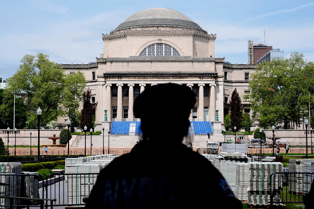 A New York City police officer looks over the center of Columbia University, in New York, May 6, 2024 (AP)