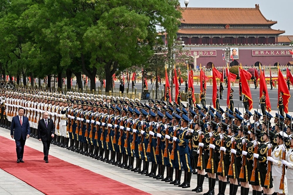 Chinese President Xi Jinping, left, and Russian President Vladimir Putin review the honor guard during an official welcome ceremony in Beijing, China, Thursday, May 16, 2024. (AP)