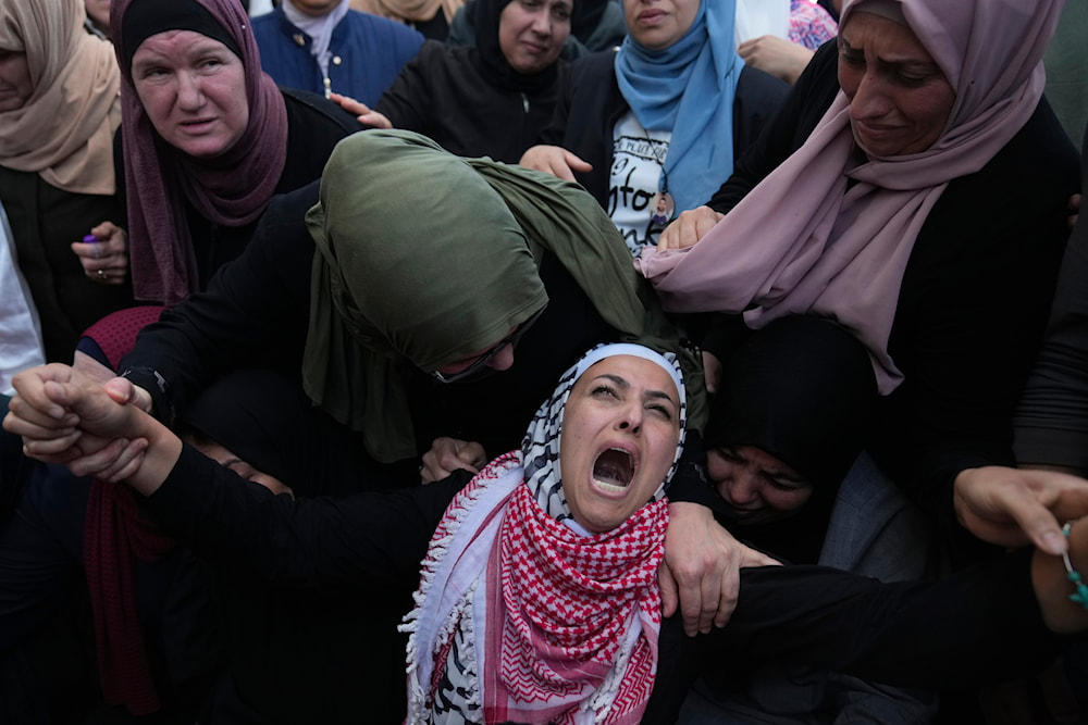 Palestinian Fayrouz Safi cries while she takes the last look at the body of her son Aysar Safi, 20, at the family house during his funeral in the West Bank refugee camp of Jalazoun, north of Ramallah Wednesday, May 15, 2024. (AP)