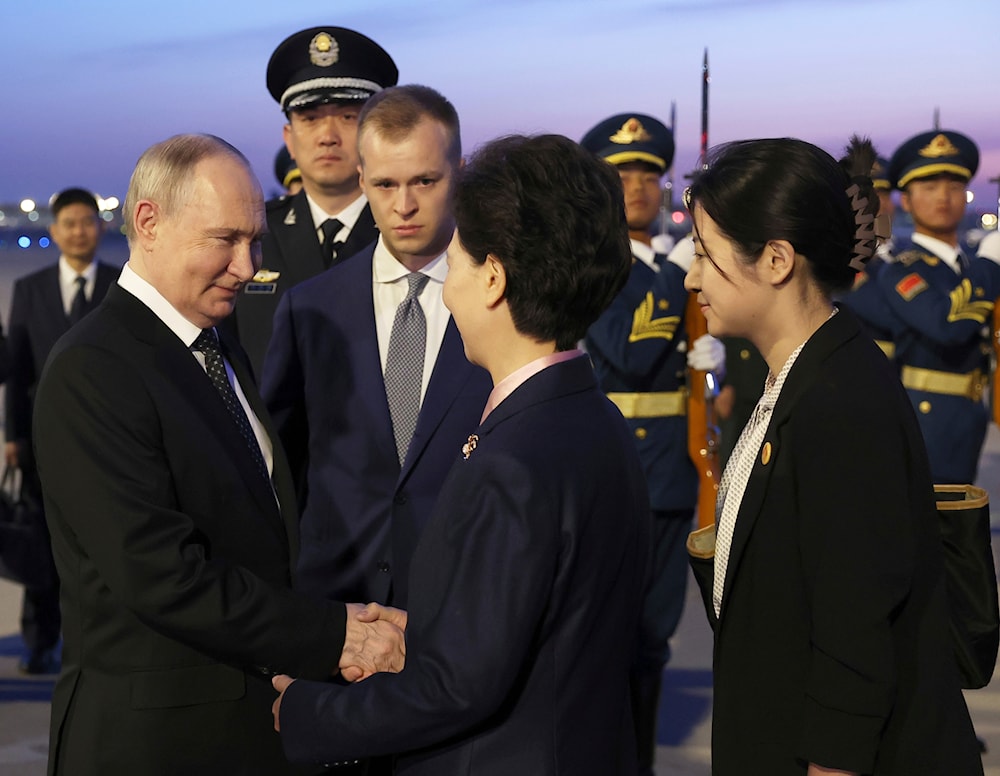 Russian President Vladimir Putin shakes hands with Chinese State Councilor Shen Yiqin upon his arrive at the Beijing Capital International Airport in Beijing, China Thursday, May 16, 2024. (AP)