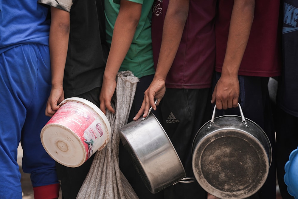 Palestinians line up for food distribution in Deir al-Balah, Gaza, May 10, 2024. (AP)