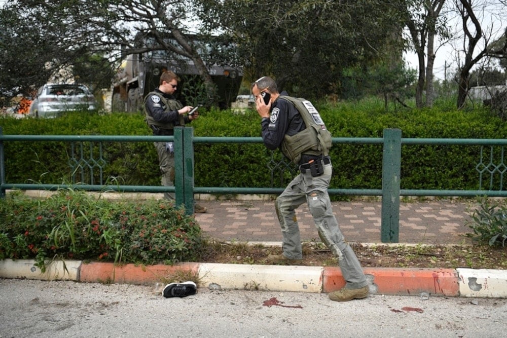 Israeli occupation forces examine the site hit by a rocked fired from Lebanon in Kiryat Shmona, northern occupied Palestine, Tuesday, Feb. 13, 2024. (AP)