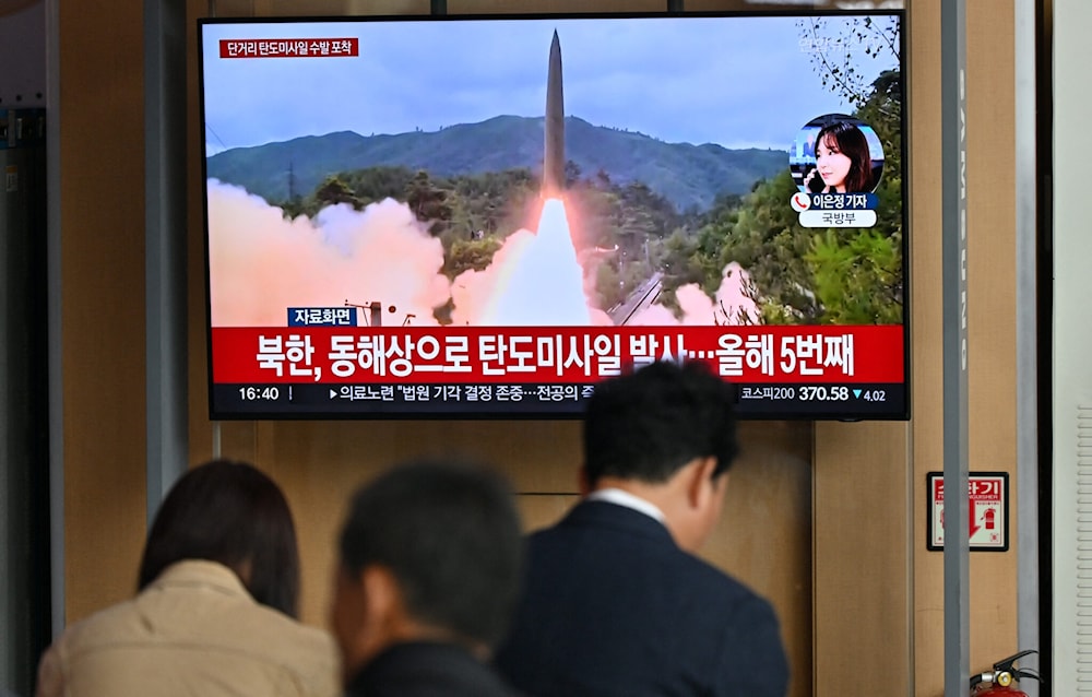 People watch a television screen showing a news broadcast with file footage of a North Korean missile test, at a railway station in Seoul on May 17, 2024. (AFP)