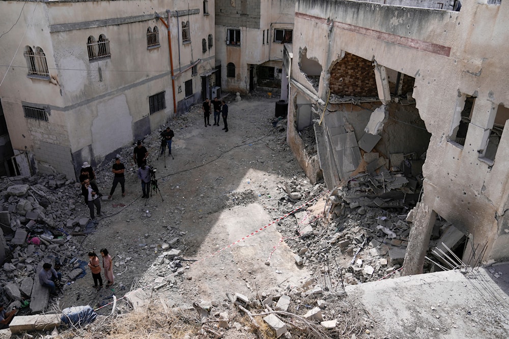 Palestinians look at the damage following an Israeli airstrike in the West Bank Jenin refugee camp, on May 18, 2024. (AP)