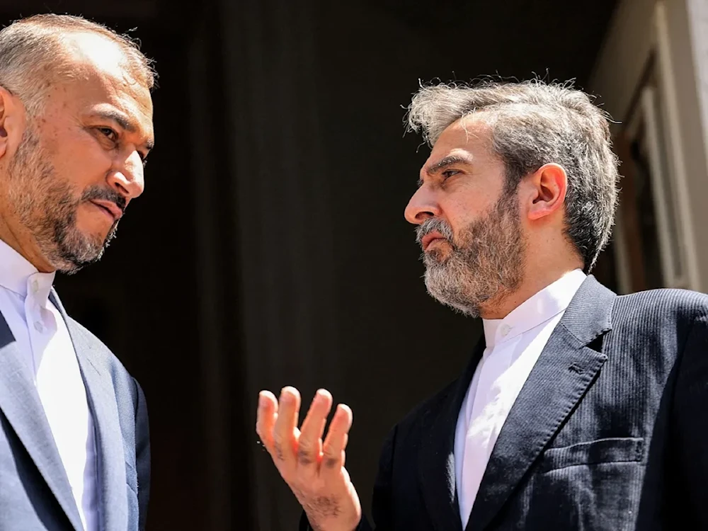 Then Foreign Minister Hossein Amir-Abdollahian and Acting Foreign Minister Ali Bagheri Kani confer before a meeting with the Russian foreign minister at the Iranian foreign ministry headquarters in Tehran on June 23. (AFP)