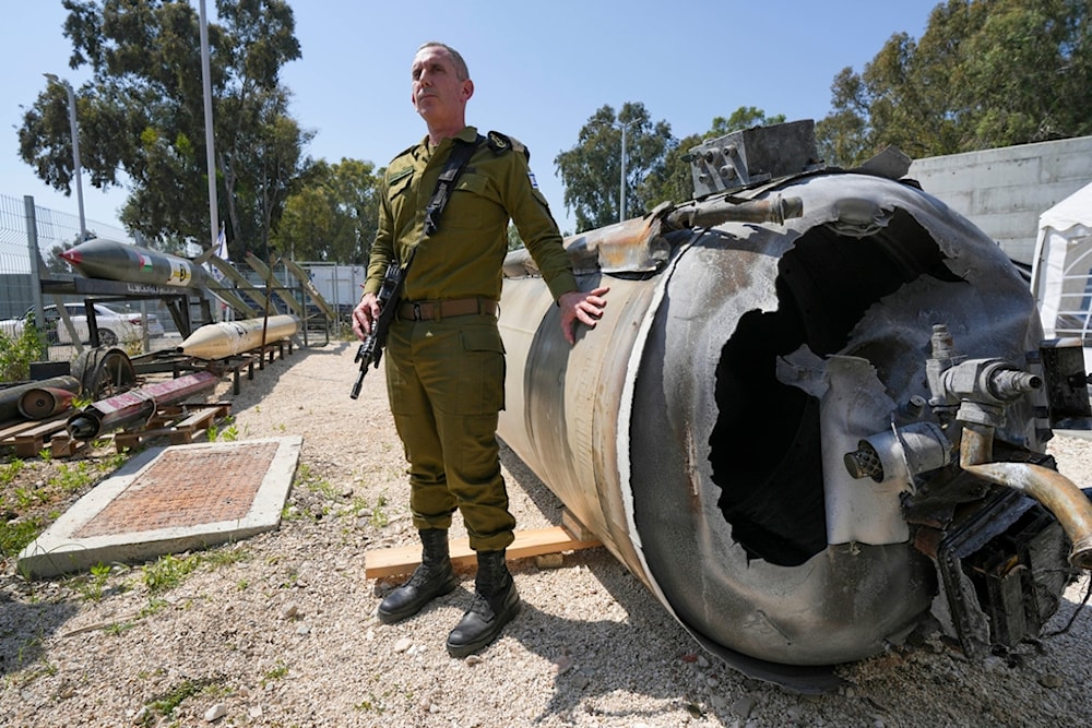 Israeli occupation forces spokesperson, Daniel Hagari, display to the media one of the Iranian ballistic missiles 'Israel' intercepted, in Julis IOF base, 'Israel', Tuesday, April 16, 2024. (AP)