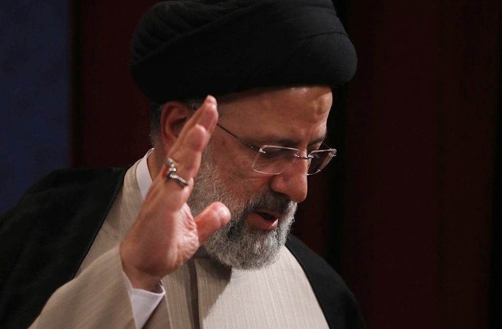 Departed Iranian President Ebrahim Raisi waves to participants as he leaves after his press conference in Tehran on June 21, 2021. (AP)