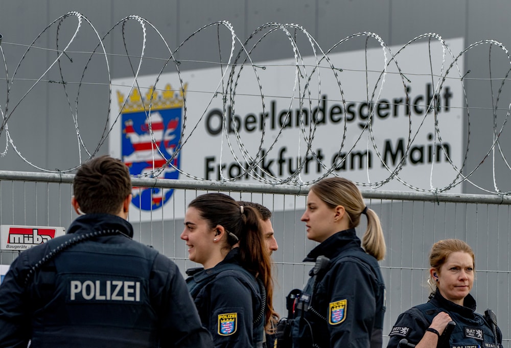 German police officers stand under barbed wire securing a temporary courtroom that was built for a trial starting on Tuesday in Frankfurt, Germany, Tuesday, May 21, 2024. (AP)