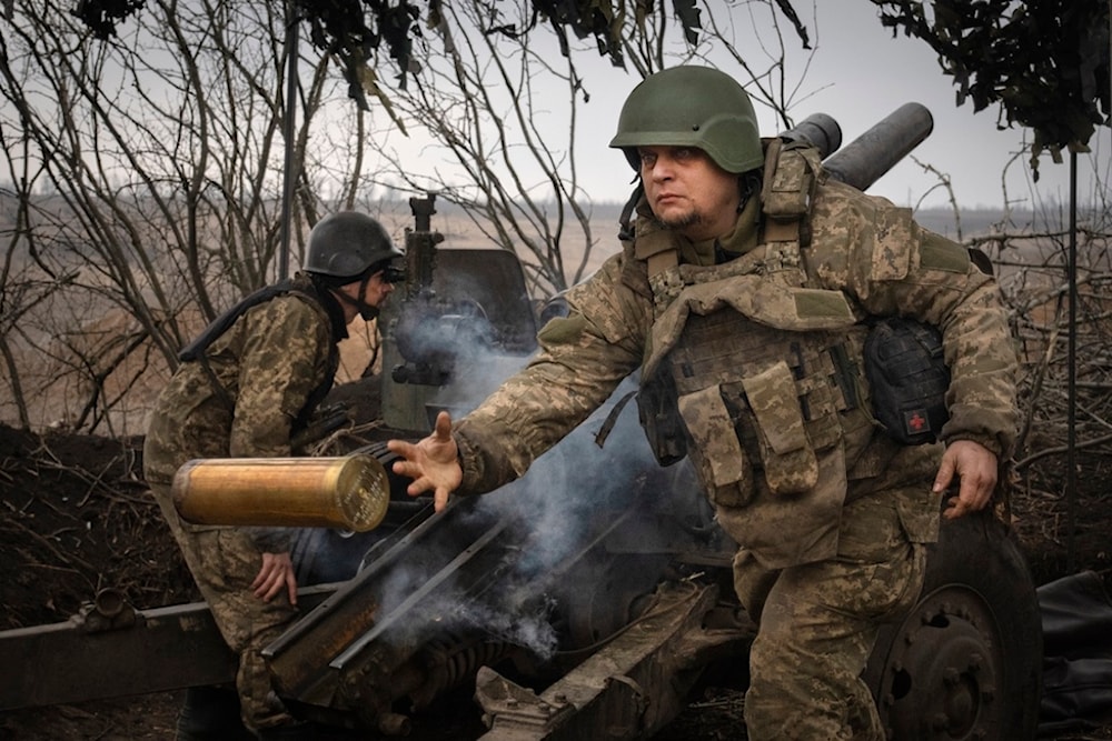 Ukrainian soldiers with the 71st Jaeger Brigade fire a M101 howitzer at Russian positions on the front line, near the city of Avdiivka in Ukraine's Donetsk region, on March 22, 2024 (AP)