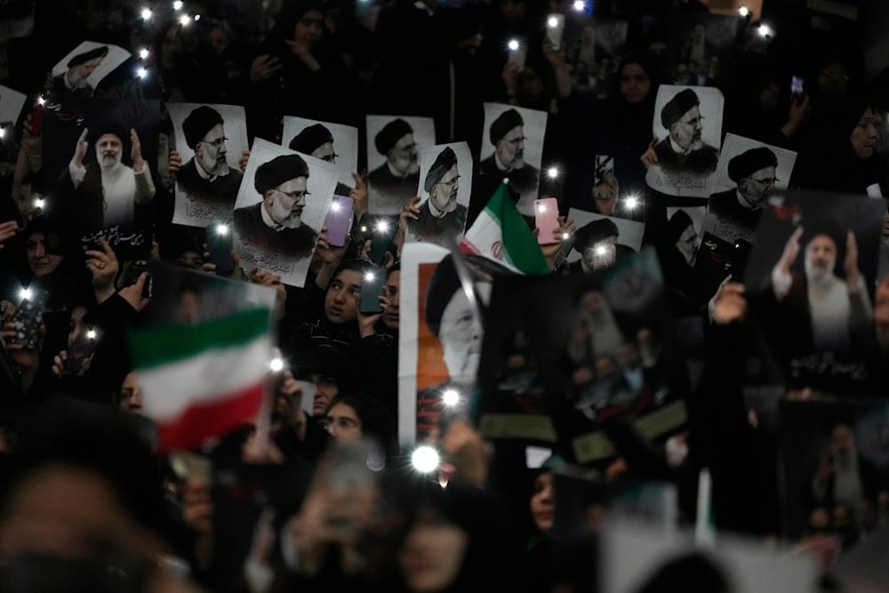 Mourners hold up posters of the late Iranian President Ebrahim Raisi at the Imam Khomeini Grand Mosque in Tehran, Iran, May 21, 2024 (AP)