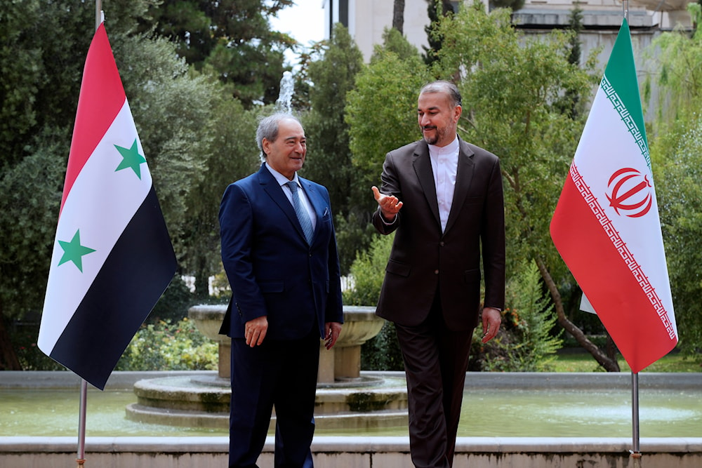 Iranian Foreign Minister Hossein Amirabdollahian, right, welcomes his Syrian counterpart Faisal al-Miqdad for their meeting in Tehran, Iran, on July 31, 2023. (AP)