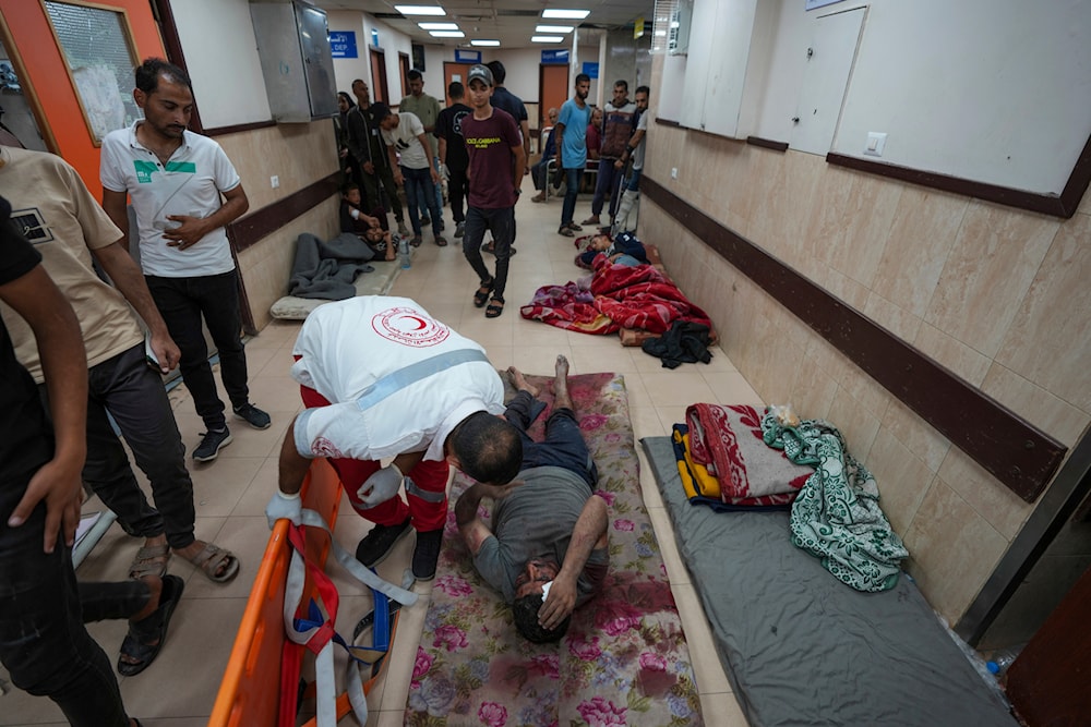 Palestinians wounded in the Israeli bombardment of the Gaza Strip are brought to al-Aqsa hospital in Deir al Balah, Gaza Strip, May 21, 2024 (AP)