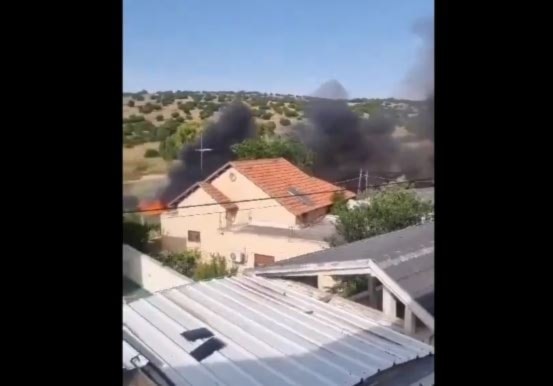 An Israeli building used by the Israeli occupation forces for military activity catches fire after being bombarded by Hezbollah in Avivim, occupied Palestine on May 22, 2024 (Military media)