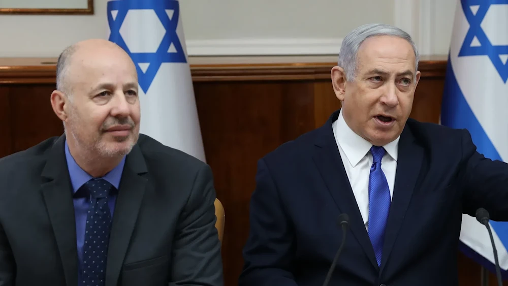 Then-Israeli minister of Regional Cooperation Tzachi Hanegbi sits with Prime Minister Benjamin Netanyahu during a Knesset session in occupied al-Quds, occupied Palestine, December 29, 2019 (AFP)