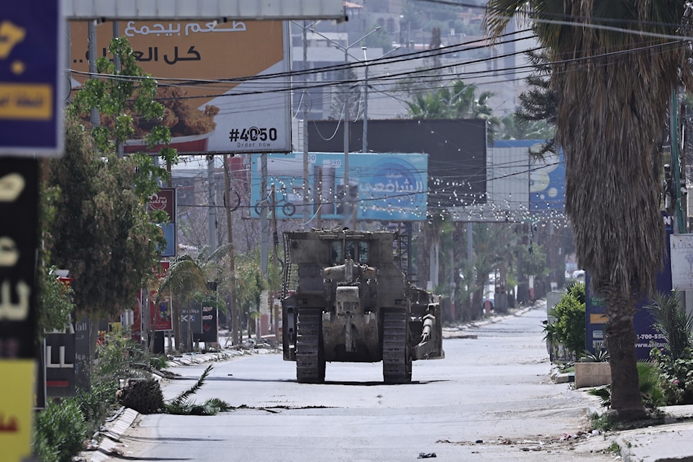 An Israeli army bulldozer invades a street during a raid in the West Bank city of Jenin, May 21, 2024. (AFP)