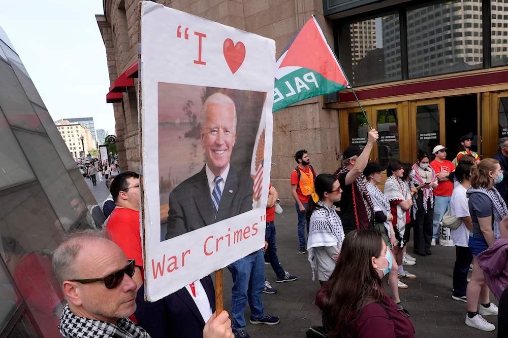 Demonstrators display a placard and chant slogans during a protest, Tuesday, May 21, 2024, in Boston. (AP)