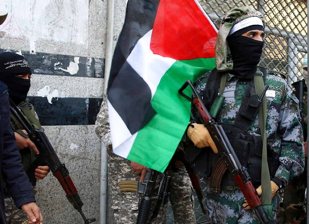Palestinian Resistance fighters hold their rifles and the Palestinian flag, in Gaza City, Palestine, Dec. 7, 2017. (AP)