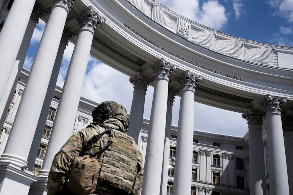 A law enforcement officer stands guard in front of the Ukrainian Ministry of Foreign Affairs during a meeting between US Secretary of State Antony Blinken and Ukrainian Foreign Minister Dmytro Kuleba, in Kiev on Wednesday, May 15, 2024. (AP)