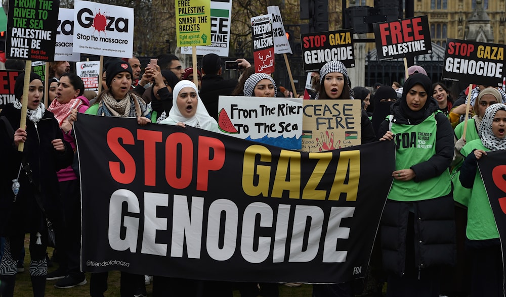 Pro-Palestinian protesters hold banners and placards ahead of a march in support of the Palestinian people in Gaza, in London, Saturday, April 27, 2024. (AP)