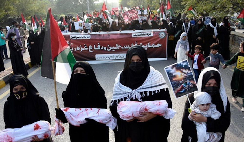 Supporters of Majlis Wahdat-e-Muslimeen carry mock dead bodies during a protest against Israeli air strikes on Gaza, to show solidarity with Palestine, in Islamabad, Pakistan. (AP)