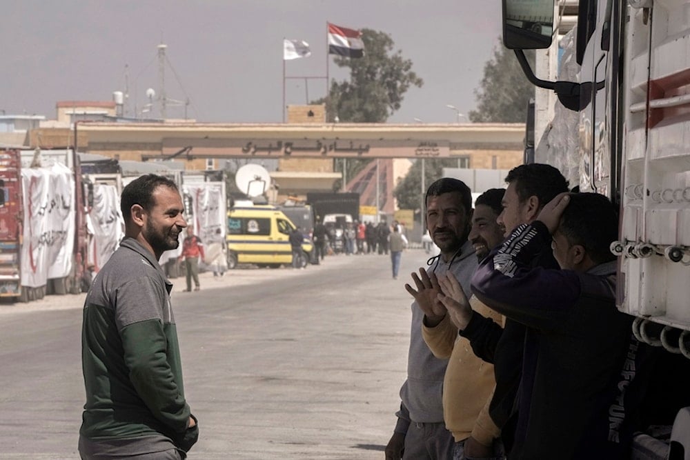 Egyptian truck drivers carrying humanitarian aids chat as they wait to cross the Rafah border crossing between Egypt and the Gaza Strip, Palestine, March.23, 2024. (AP)