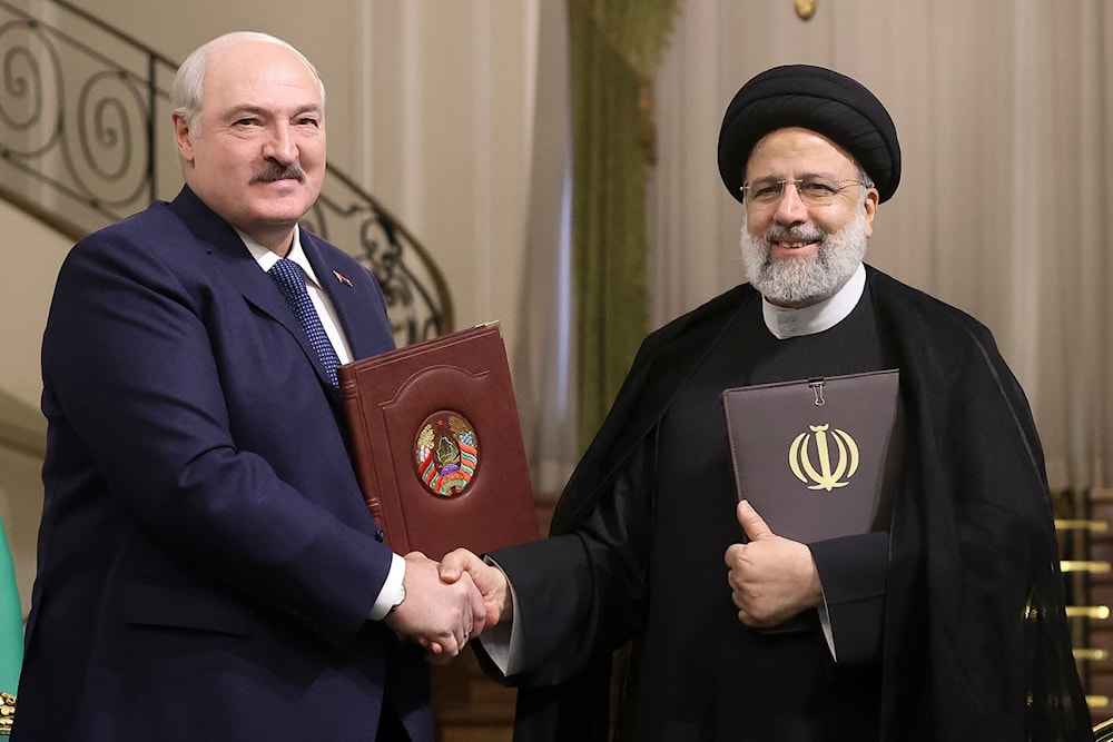 Iranian President Ebrahim Raisi with Belarusian President Alexander Lukashenko after a signing ceremony following their talks at the Saadabad Palace in Tehran, Iran, Monday, March 13, 2023. (AP)