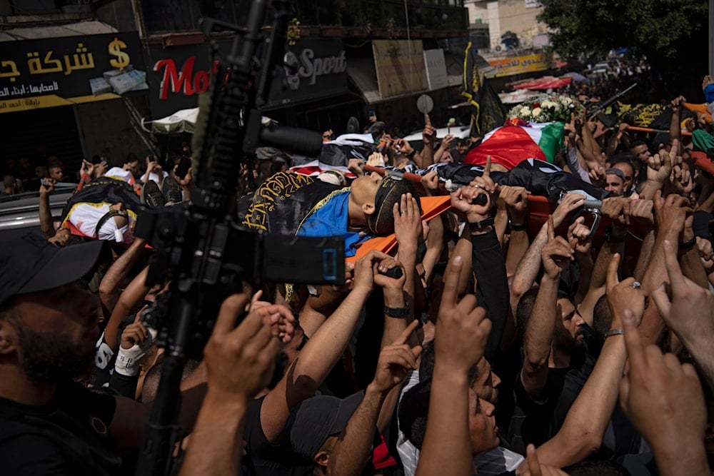 Mourners carry the bodies of Palestinians killed by IOF during their funeral in the West Bank city of Jenin, on Thursday, May 23, 2024. (AP)