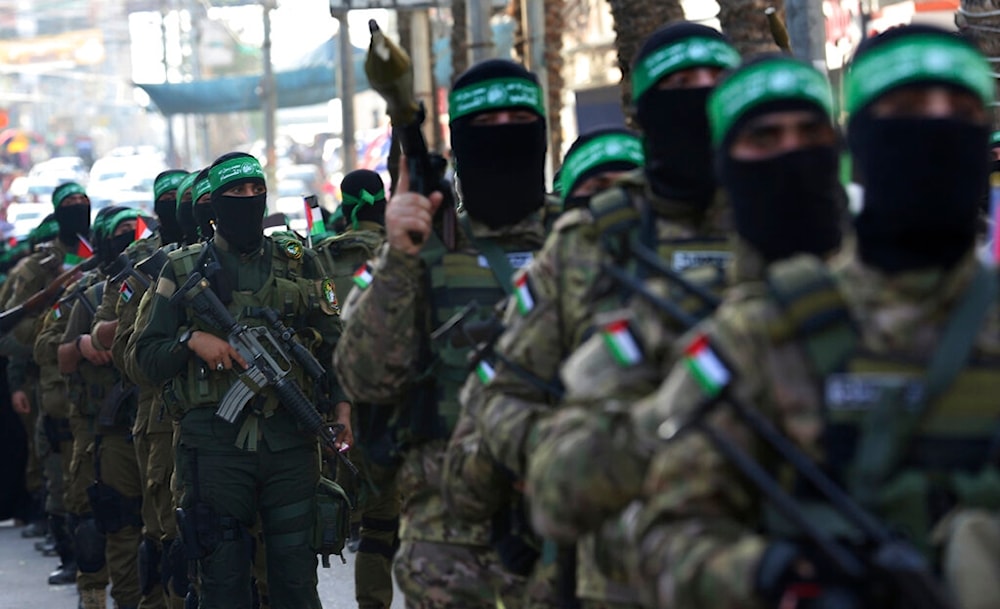 Masked fighters from the al-Qassam Brigades, a military wing of Hamas, march along the streets of al-Nuseirat refugee camp, central Gaza Strip, Friday, May 28, 2021 (AP)