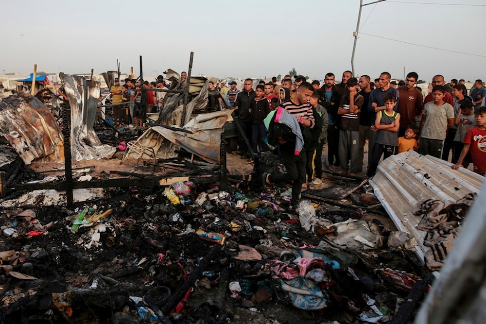 Palestinians look at the destruction after an Israeli strike where displaced people were staying in Rafah, Gaza Strip, Monday, May 27, 2024. (AP)
