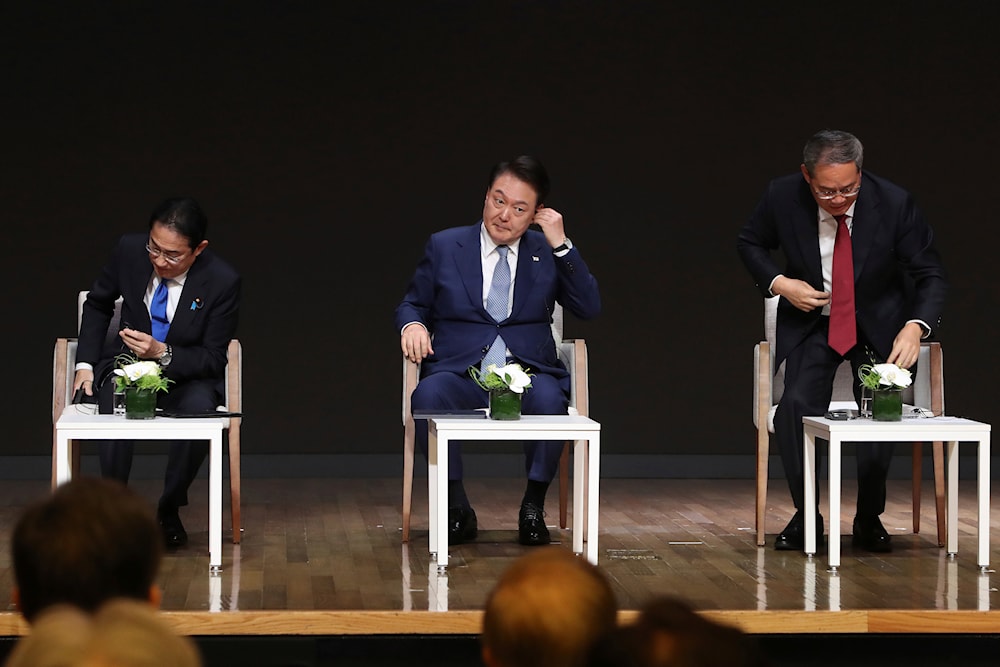 Japanese Prime Minister Fumio Kishida, from left, South Korean President Yoon Suk Yeol, and Chinese Premier Li Qiang attend a business meeting at the Korea Chamber of Commerce and Industry in Seoul, South Korea, May 27, 2024 (AP)