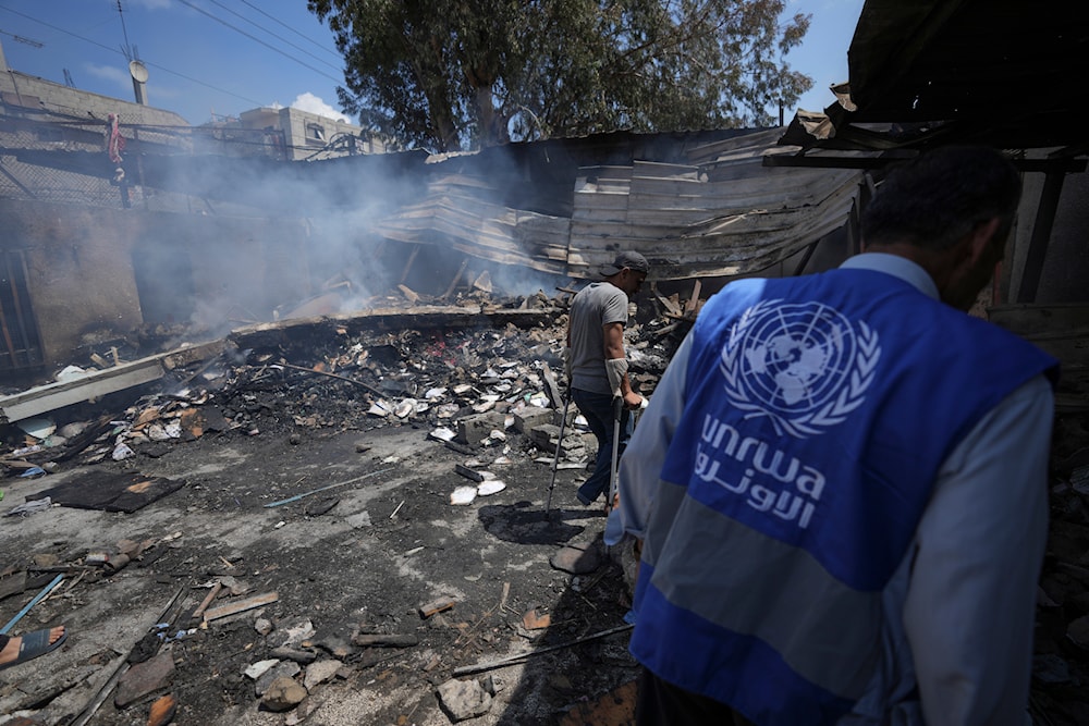 Palestinians look at the destruction after an Israeli strike on a school run by UNRWA, the UN agency helping Palestinian refugees, in Nuseirat, Gaza Strip, Tuesday, May 14, 2024. (AP)