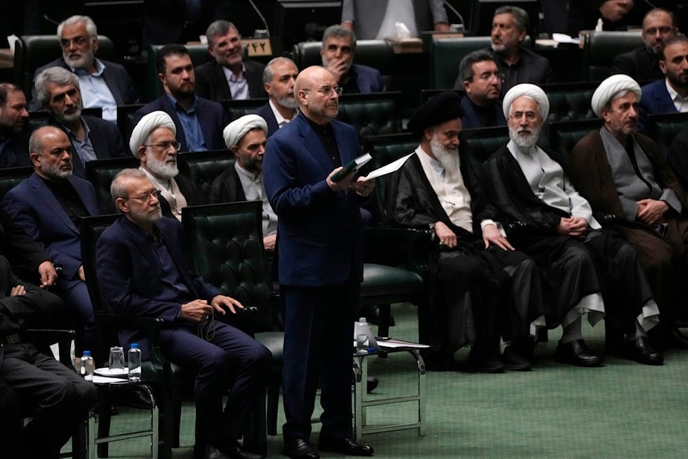 Mohammad Bagher Qalibaf, center, takes an oath during the opening ceremony of the new parliament term in Tehran, Iran, May 27, 2024 (AP)