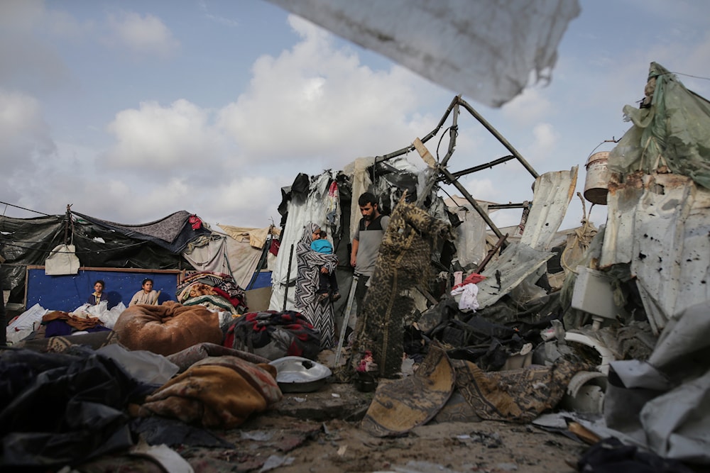 Displaced Palestinians inspect their tents destroyed by Israeli bombardment, adjunct to a UNRWA facility west of Rafah city, Gaza Strip, Tuesday, May 28, 2024. (AP)