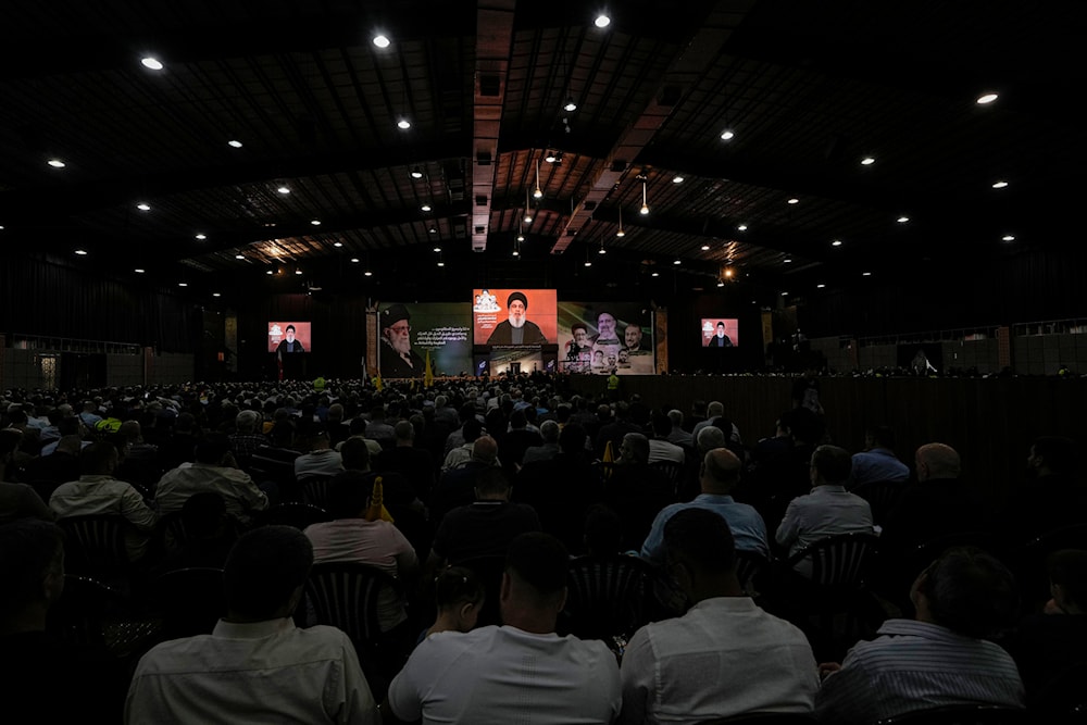 Hezbollah leader Sayyed Hassan Nasrallah speaking on a screen via a video link in the southern Beirut suburb of Dahiyeh, Lebanon, May 25, 2024 (AP)