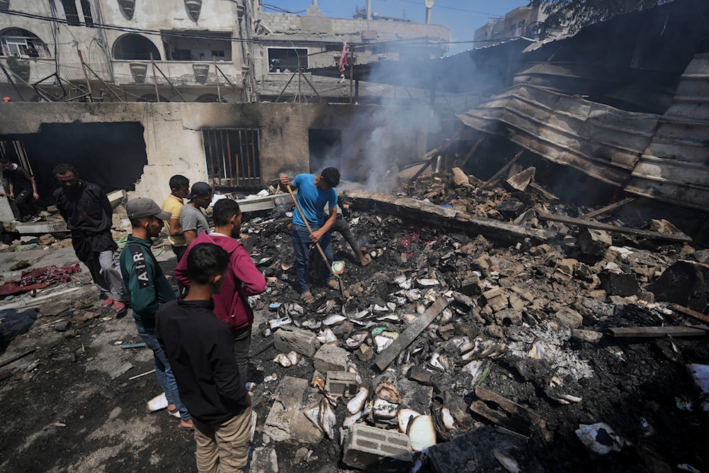 Palestinians search debris after an Israeli strike on a school run by UNRWA, the UN agency helping Palestinian refugees, in al-Nuseirat, Gaza Strip, Tuesday, May 14, 2024. (AP)