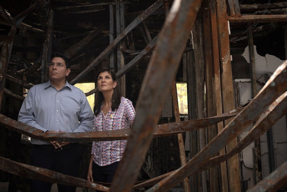 Danny Danon, a member of the Knesset, and Nikki Haley, former US Ambassador to the UN, visit a home in Kibbutz Nir Oz on Monday, May 27, 2024. (AP)