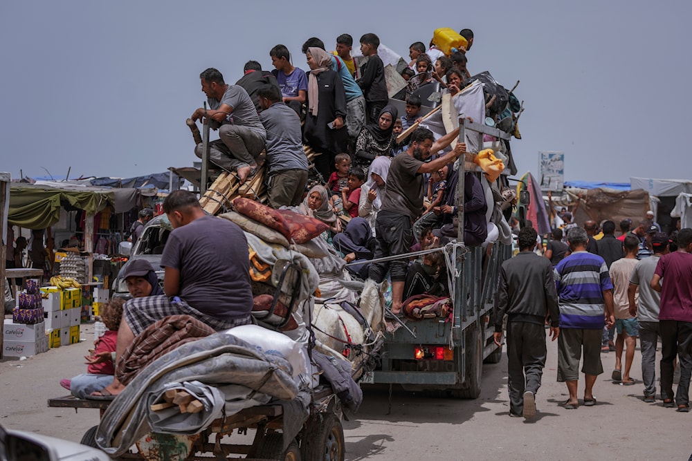 Palestinians fleeing from the southern Gaza city of Rafah during an Israeli ground and air offensive in the city on May 28, 2024 (AP)