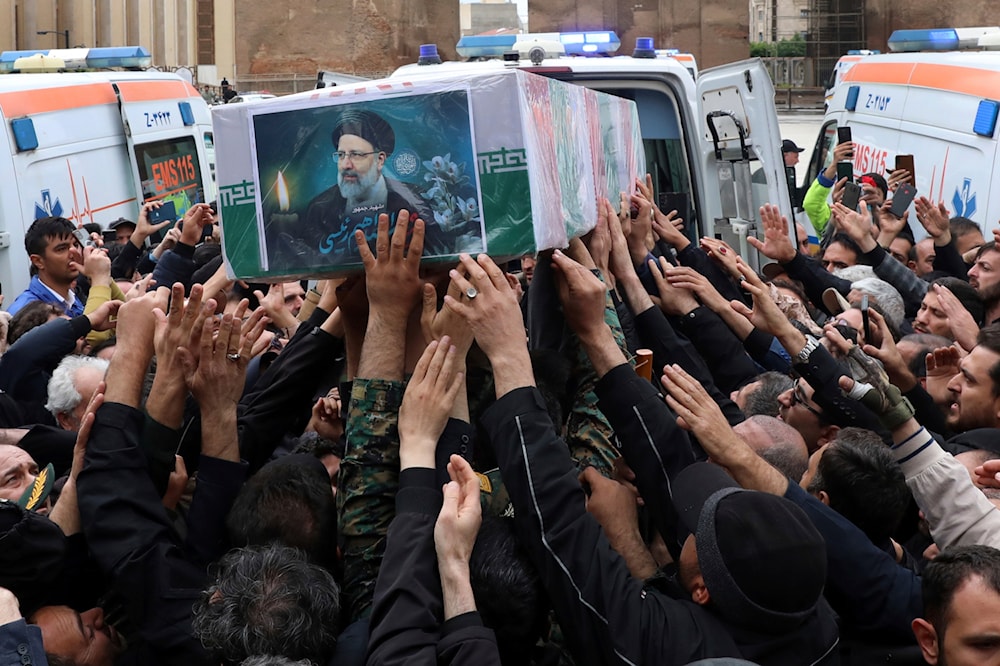 Mourners carry the flag-draped coffin of President Ebrahim Raisi during a funeral ceremony for him and his companions in the city of Tabriz, Iran, May 21, 2024 (AP)