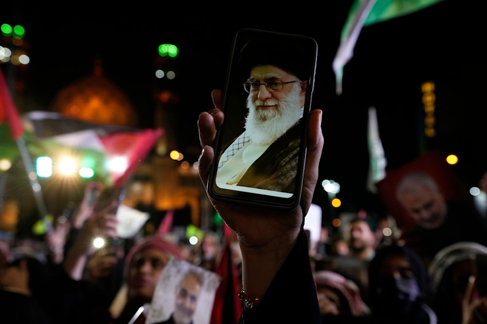 An Iranian demonstrator shows a photos of the Supreme Leader Ayatollah Ali Khamenei on the screen of her cellphone in a pro-Palestinian rally at the Felestin (Palestine) Sq. in Tehran, Iran, Friday, Oct. 20, 2023. (AP)