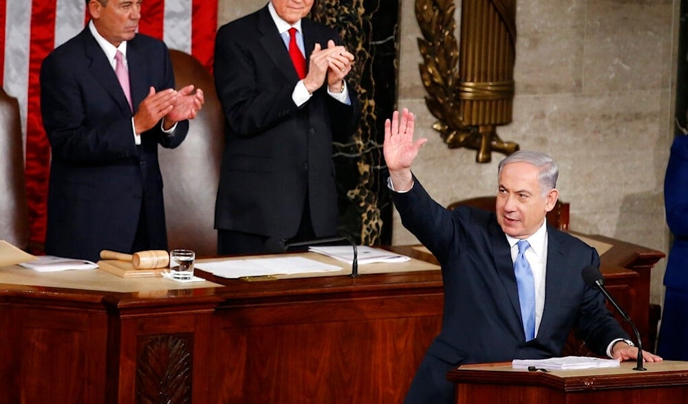 Israeli occupation Prime Minister Benjamin Netanyahu waves as he steps to the podium prior to speaking before a joint meeting of Congress on Capitol Hill in Washington, US, March 3, 2015. (AP)