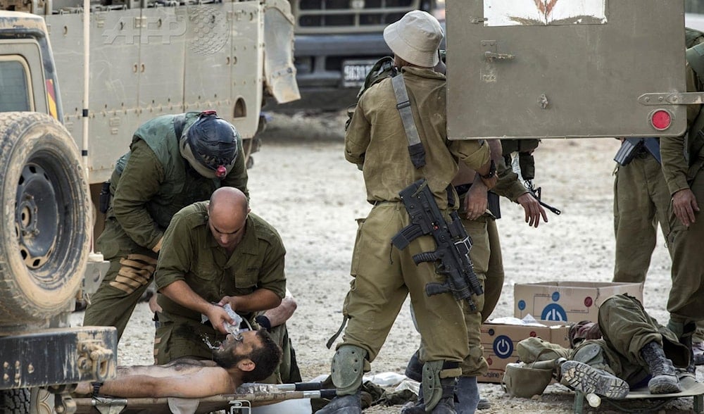 Israeli soldiers evacuating an injured soldier in Gaza in an undated picture (AFP)