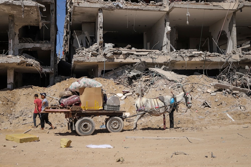 Palestinians salvage items from the destruction in the wake of the Israeli genocide in Jabaliya, northern Gaza Strip after Israeli occupation forces withdrew from the area, Friday, May 31, 2024. (AP)