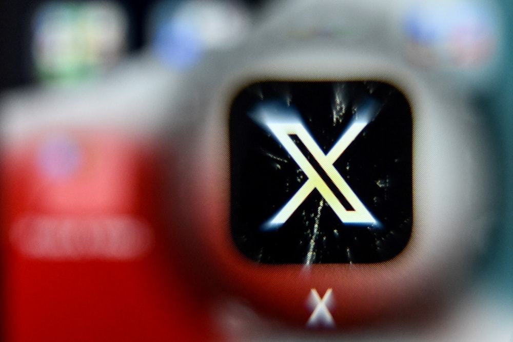 A photo taken November 17, 2023 shows the logo of social networking service X, on a smartphone screen (AFP)