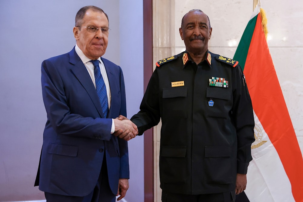 In this photo released by Russian Foreign Ministry Press Service, Russian Foreign Minister Sergey Lavrov, left, and Sudan's Army chief Gen. Abdel-Fattah Burhan pose for a photo during their meeting in Khartoum, Sudan, on February 9, 2023. (AP)