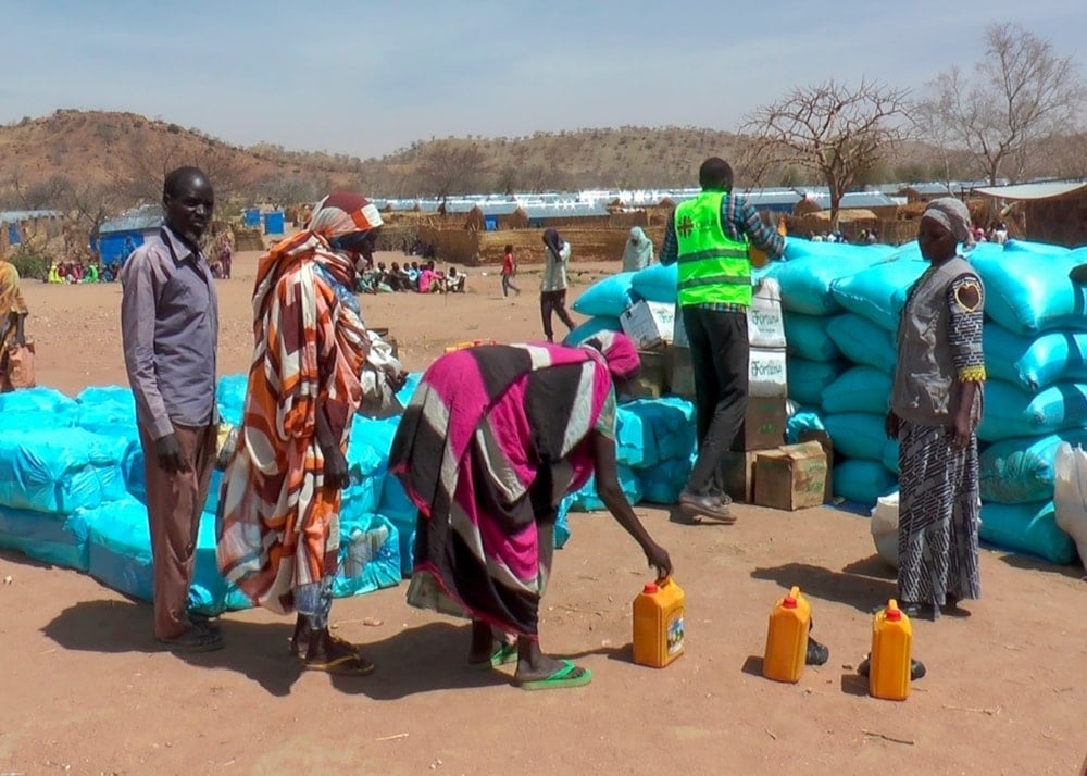 Sudanese refugees displaced by the conflict in Sudan gather to receive food staples from aid agencies at the Metche Camp in eastern Chad, on Tuesday, March 5, 2024. (AP)